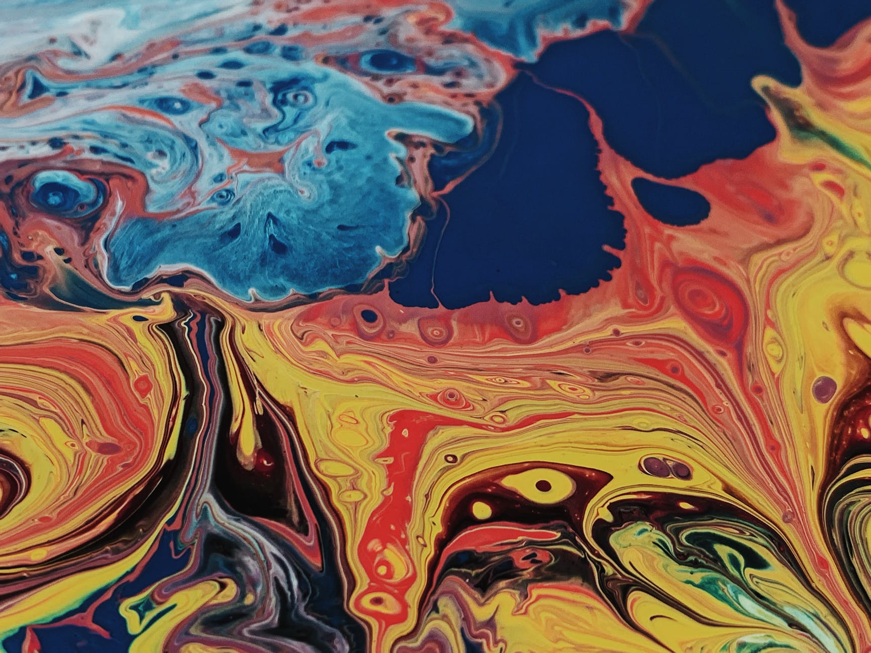abstract background of chaotic spreading paints across surface